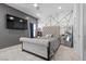 A modern bedroom features a large flat screen television, interesting wall art, and a queen-sized bed at 3 Vicolo Sebino, Henderson, NV 89011