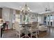 Spacious dining room features a chandelier, and a round table with seating for six and luxury vinyl plank flooring at 3 Vicolo Sebino, Henderson, NV 89011
