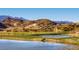 Tranquil golf course view with a pond and mountain backdrop in a scenic desert setting at 3 Vicolo Sebino, Henderson, NV 89011