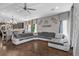 The living room features hard wood floors and stylish gray couches with gray and white patterned curtains at 3 Vicolo Sebino, Henderson, NV 89011