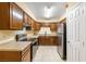 Well-lit kitchen featuring wooden cabinets, granite countertops, and stainless steel appliances at 3151 Soaring Gulls Dr # 1066, Las Vegas, NV 89128