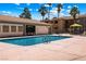 Stunning community pool surrounded by palm trees, and seating, offering a refreshing oasis for residents at 3151 Soaring Gulls Dr # 1066, Las Vegas, NV 89128