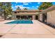 Inviting community pool area with seating and a meticulously maintained pool surrounded by lush landscaping at 3151 Soaring Gulls Dr # 1066, Las Vegas, NV 89128