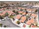 Residential neighborhood featuring red tile roofs, landscaped yards, and well-maintained streets under a clear sky at 317 Brent Ct, Henderson, NV 89074