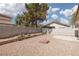 Low maintenance backyard with gravel, block wall, and built-in seating areas at 317 Brent Ct, Henderson, NV 89074