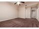 Bedroom with ceiling fan, carpet flooring and view of bathroom and closet at 317 Brent Ct, Henderson, NV 89074