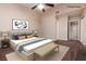 Cozy bedroom featuring neutral decor, a ceiling fan and a comfortable bed with a seating bench at 317 Brent Ct, Henderson, NV 89074