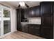 Kitchen features hardwood style flooring and ample cabinet space with modern microwave at 317 Brent Ct, Henderson, NV 89074