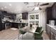 Modern kitchen with stainless steel appliances, dark cabinets, and a dining area with a sliding glass door at 317 Brent Ct, Henderson, NV 89074