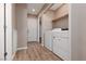 Laundry room with washer and dryer hookups and laminate hardwood flooring throughout at 317 Brent Ct, Henderson, NV 89074