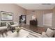 Living room showcasing modern decor, vaulted ceilings and an open view into the kitchen and dining area at 317 Brent Ct, Henderson, NV 89074