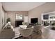 Comfortable living room with stylish seating, fireplace, and view of the kitchen at 317 Brent Ct, Henderson, NV 89074