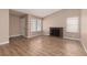 Open living room with wood floors and a brick fireplace at 317 Brent Ct, Henderson, NV 89074