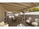 Cozy covered patio with ample seating, fire pit, and dining area create a relaxing outdoor space at 317 Brent Ct, Henderson, NV 89074