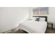 Minimalist bedroom with a queen-sized bed, simple furnishings, and a serene ambiance at 3208 Alcoa Ave, Las Vegas, NV 89102