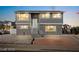 Attractive two-story gray home with white trim and updated landscaping, offering curb appeal at 3208 Alcoa Ave, Las Vegas, NV 89102
