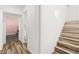 Hallway with wooden stairs leading to the upper level and light colored hardwood floors at 3208 Alcoa Ave, Las Vegas, NV 89102