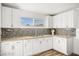 Bright kitchen featuring white cabinets, stylish backsplash, and granite countertops at 3208 Alcoa Ave, Las Vegas, NV 89102