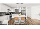 Bright kitchen showcases white cabinetry, an island with seating, and stainless steel appliances at 3208 Alcoa Ave, Las Vegas, NV 89102