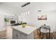 Open concept kitchen with an island that flows into the living and dining spaces at 3208 Alcoa Ave, Las Vegas, NV 89102