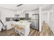 Modern kitchen features white cabinets, island with seating, and stainless steel appliances at 3208 Alcoa Ave, Las Vegas, NV 89102
