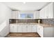 Bright kitchen featuring white cabinets, tiled backsplash, laminate countertops, and stainless steel appliances at 3208 Alcoa Ave, Las Vegas, NV 89102