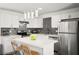Modern kitchen with stainless steel appliances, white cabinets, and mosaic tile backsplash at 3208 Alcoa Ave, Las Vegas, NV 89102