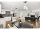 Open-concept living area with modern kitchen, island seating, and hardwood flooring at 3208 Alcoa Ave, Las Vegas, NV 89102