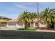 Charming single-story home with a three-car garage and well-manicured lawn with beautiful palm trees at 3684 Miguels Ln, Las Vegas, NV 89120