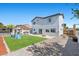 View of the backyard with artificial grass, a basketball hoop, and a slide at 3871 Trellis View Ave, Las Vegas, NV 89115