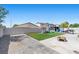 Backyard with artificial grass, stone pavers, and a fire pit at 3871 Trellis View Ave, Las Vegas, NV 89115