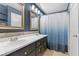 Bathroom featuring double sinks, blue walls, and a bathtub with shower at 3871 Trellis View Ave, Las Vegas, NV 89115