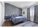 Serene bedroom with a decorative blue comforter, hardwood floors, and modern decor at 3871 Trellis View Ave, Las Vegas, NV 89115