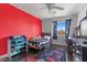 Fun bedroom with a red accent wall, a window overlooking mountain views, and a gaming-themed rug at 3871 Trellis View Ave, Las Vegas, NV 89115