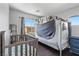 Bedroom features hardwood flooring and a crib with a protective tent at 3871 Trellis View Ave, Las Vegas, NV 89115