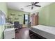 Cozy bedroom featuring wood floors, ceiling fan, desk and wardrobe at 3871 Trellis View Ave, Las Vegas, NV 89115