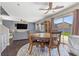 Cozy dining area featuring a round wood table and chairs, adjacent to a bright living space at 3871 Trellis View Ave, Las Vegas, NV 89115