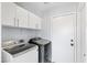 Convenient laundry room with modern washer and dryer units and built in storage at 3871 Trellis View Ave, Las Vegas, NV 89115