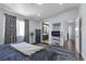 Spacious main bedroom with an adjacent bathroom and a large window at 3871 Trellis View Ave, Las Vegas, NV 89115