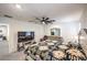 Bright bedroom featuring contemporary furnishings, a large TV, and an open doorway to a workout area at 4145 Nopal Serrano Ave, Las Vegas, NV 89141