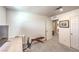 A functional office area features a desk, exercise equipment, and access to other rooms at 4145 Nopal Serrano Ave, Las Vegas, NV 89141