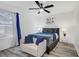 Cozy bedroom featuring large window, modern ceiling fan and hardwood floors at 4200 S Valley View Blvd # 1120, Las Vegas, NV 89103