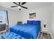 Bright bedroom featuring modern ceiling fan, grey accent chair, and matching blue bed set at 4200 S Valley View Blvd # 1120, Las Vegas, NV 89103
