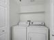 Laundry room with a white washer and dryer, as well as a storage shelf at 4200 S Valley View Blvd # 1120, Las Vegas, NV 89103