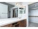 Bathroom featuring a tiled vanity counter, dual mirrors, and an entrance to a walk-in closet at 426 Lost Trail Dr, Henderson, NV 89014