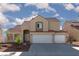 Charming two-story house showing red tile roof, desert landscaping, and a convenient two-car garage at 426 Lost Trail Dr, Henderson, NV 89014