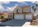 Lovely two-story house featuring a red tile roof, desert landscaping, and a spacious two-car garage at 426 Lost Trail Dr, Henderson, NV 89014