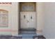 Close-up showcasing the double front doors with a decorative window above, set in a stucco exterior at 426 Lost Trail Dr, Henderson, NV 89014
