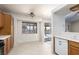 Bright kitchen area with wood cabinetry, tiled countertops, and a sliding door to the pool area at 426 Lost Trail Dr, Henderson, NV 89014