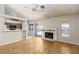 Cozy living room featuring a fireplace, ceiling fan, and sliding door access to the backyard at 426 Lost Trail Dr, Henderson, NV 89014